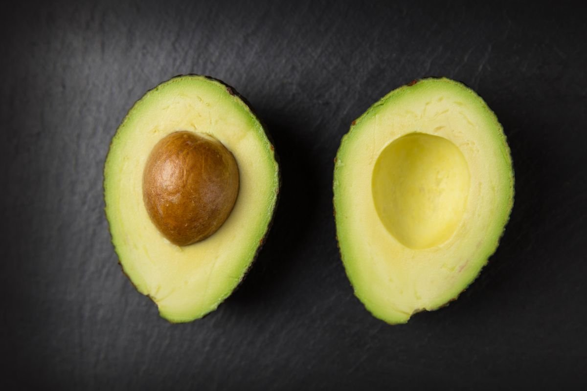 Sliced and whole avocados