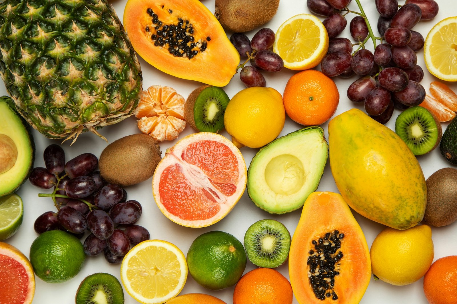 Assortment of fresh fruits including berries, citrus and tropical produce